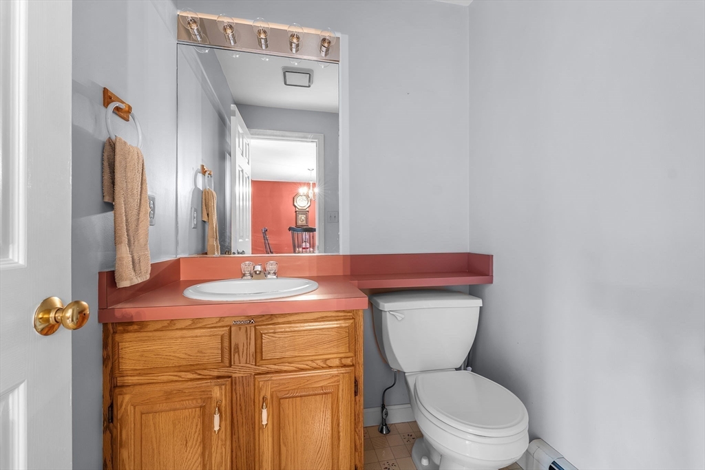 38 High Street, Unit 8 Hanson, MA 02341 - Photo 18 of 37 a bathroom with a granite countertop toilet sink and mirror