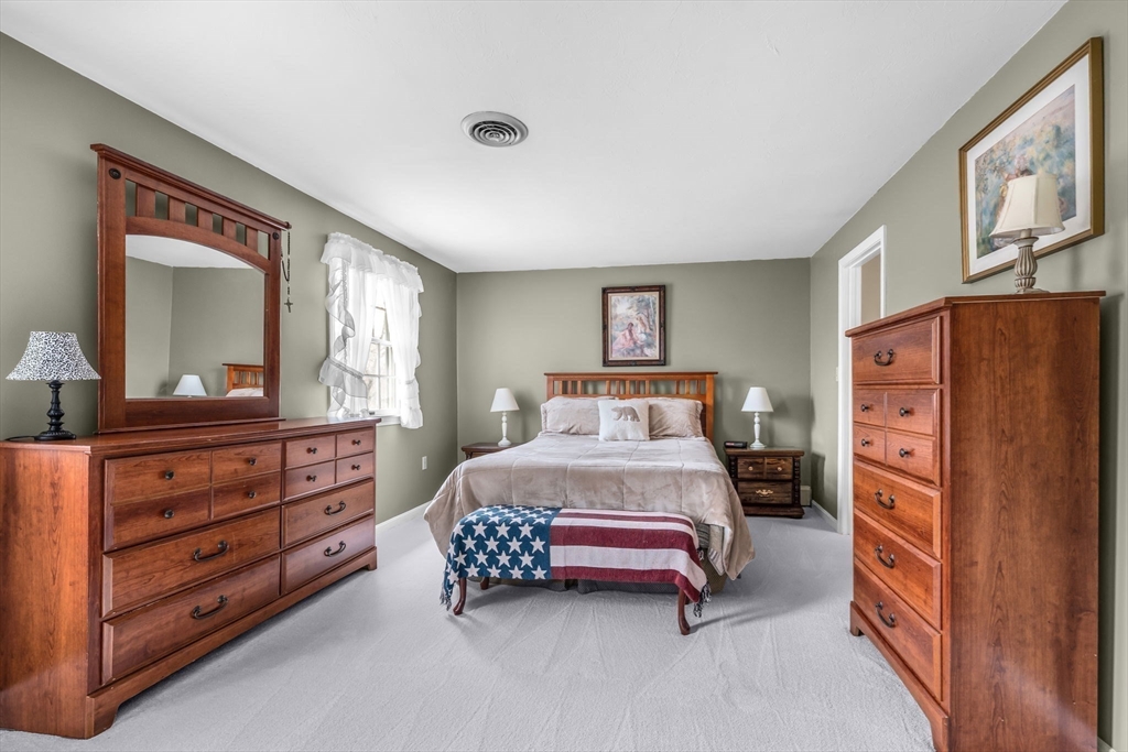 38 High Street, Unit 8 Hanson, MA 02341 - Photo 19 of 37 a bedroom with a bed and a dresser