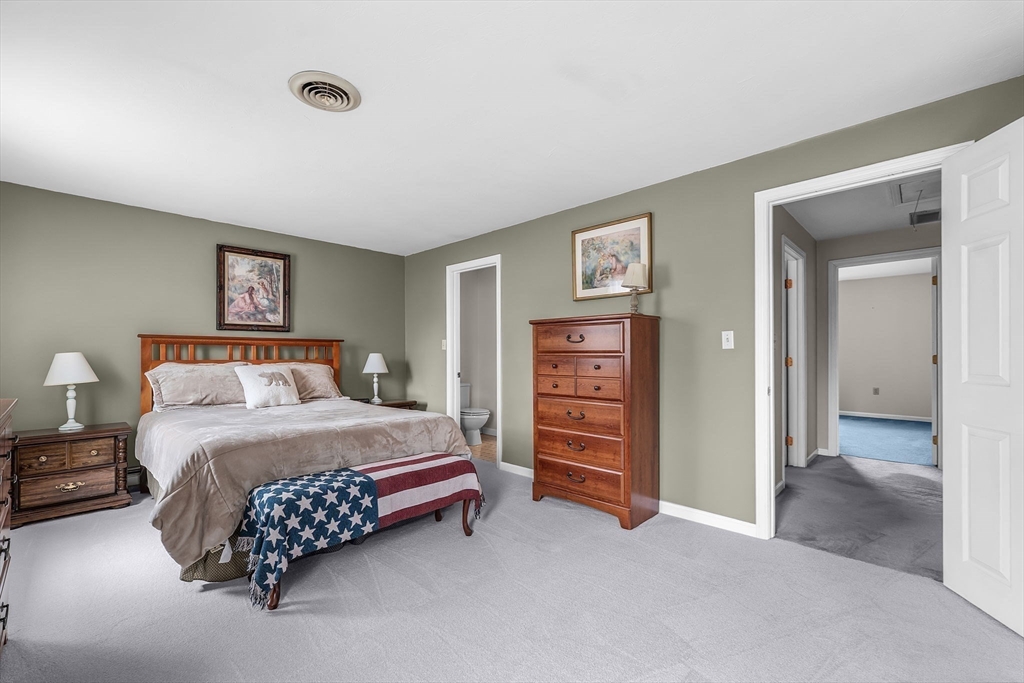 38 High Street, Unit 8 Hanson, MA 02341 - Photo 20 of 37 a bedroom with a bed and a lamp on dresser