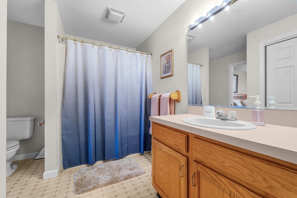 38 High Street, Unit 8 Hanson, MA 02341 - Photo 21 of 37 a bathroom with a sink and a mirror