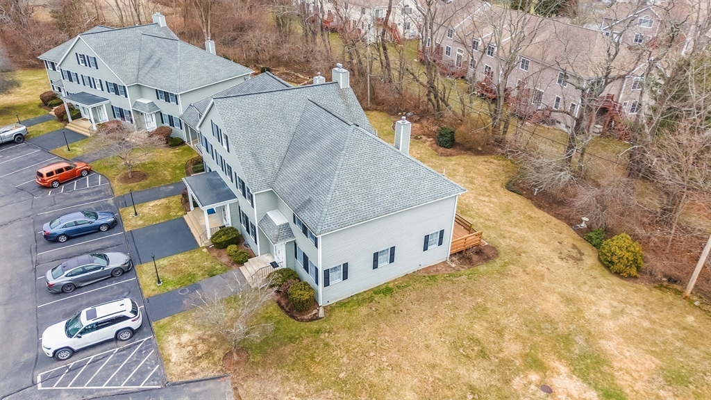 38 High Street, Unit 8 Hanson, MA 02341 - Photo 5 of 37 a white house with a yard and wooden fence