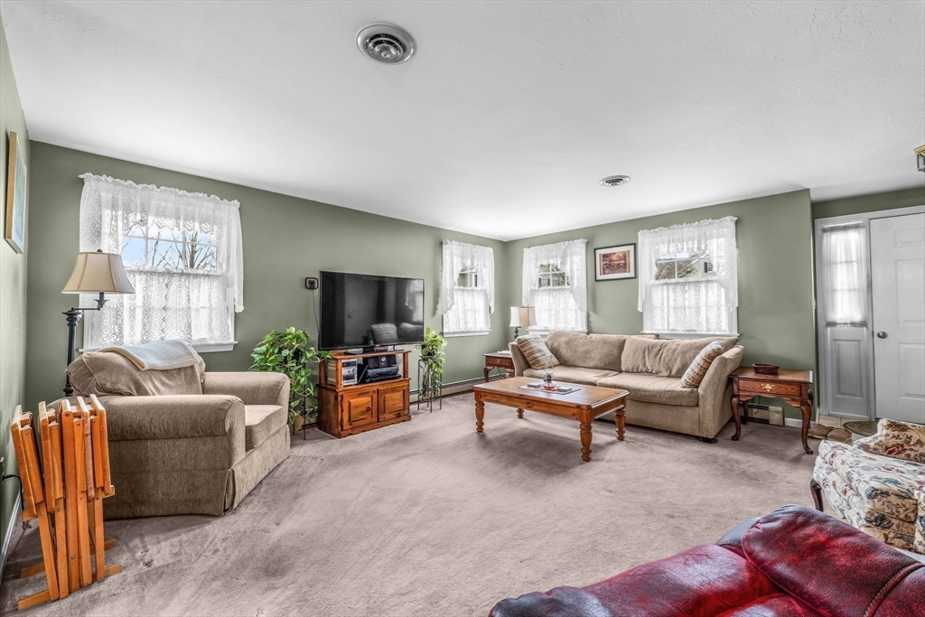 38 High Street, Unit 8 Hanson, MA 02341 - Photo 7 of 37 a living room with furniture and a flat screen tv