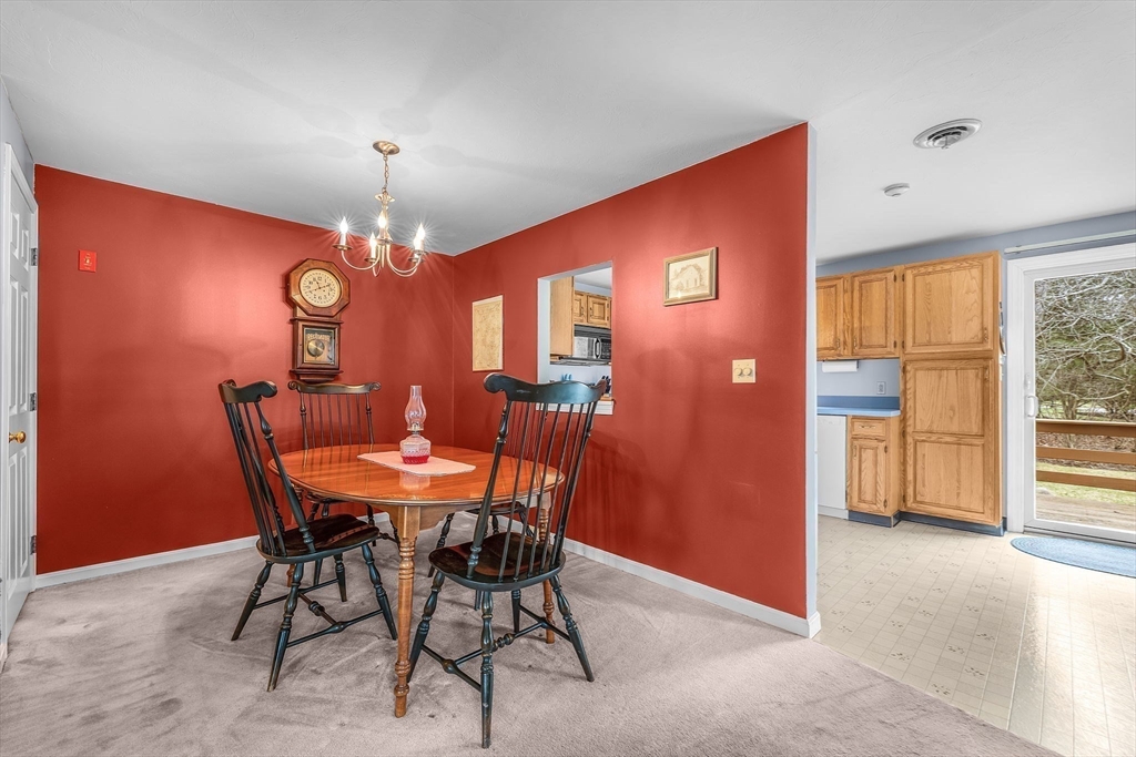 38 High Street, Unit 8 Hanson, MA 02341 - Photo 10 of 37 a view of a dining room with furniture and chandelier