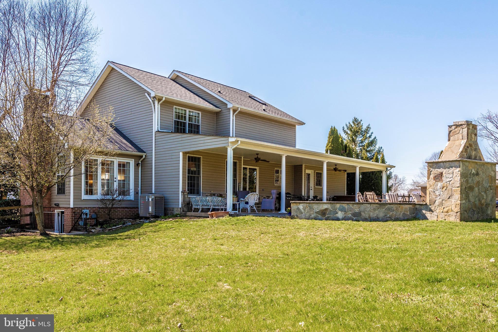 3232 Sigler Road Jefferson, MD 21755 - Photo 2 of 35 a view of a house with a yard and lawn chairs with wooden fence