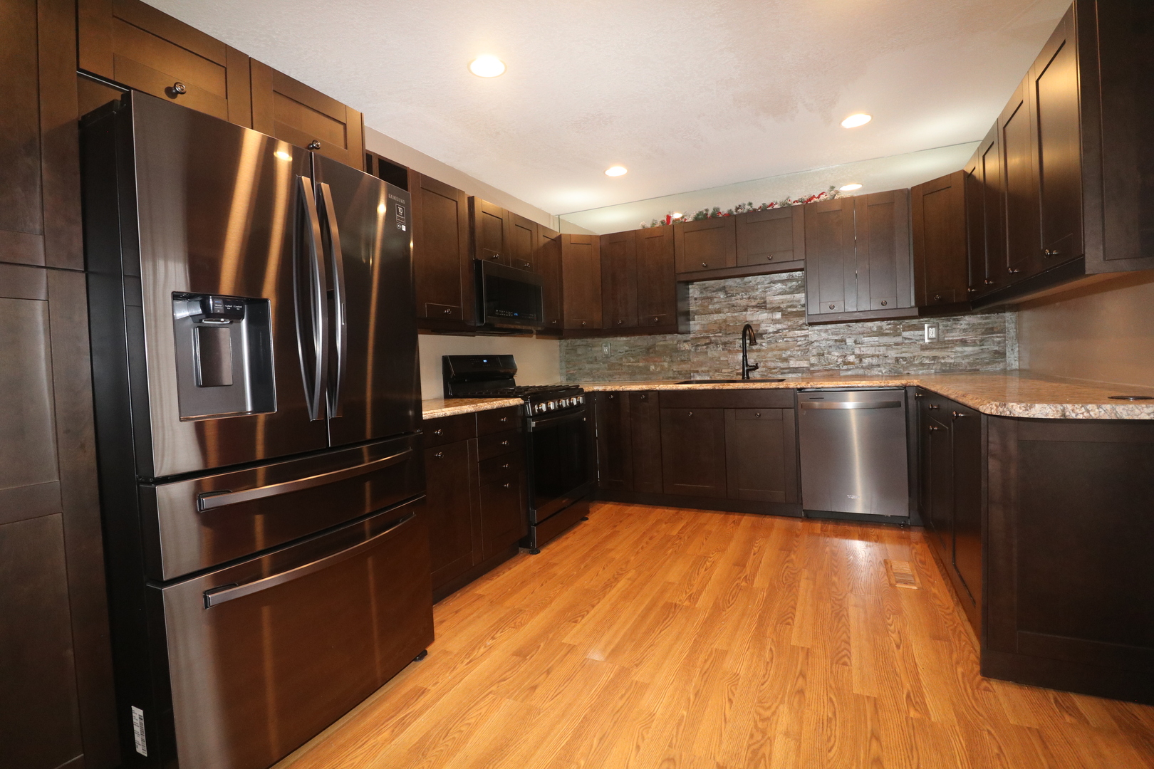 8843 Sunset Road Clinton, IL 61727 - Photo 5 of 32 a kitchen with granite countertop stainless steel appliances and wooden cabinets