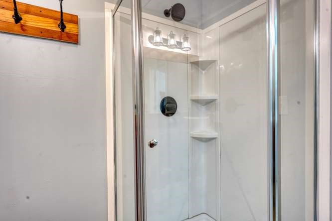 3333 Ellington Road Hayesville, NC 28904 - Photo 53 of 56 a bathroom with a mirror and a shower