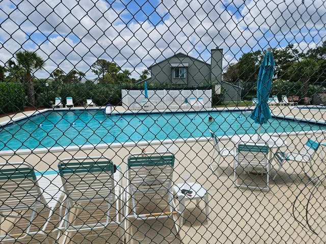 a view of wooden fence and trees