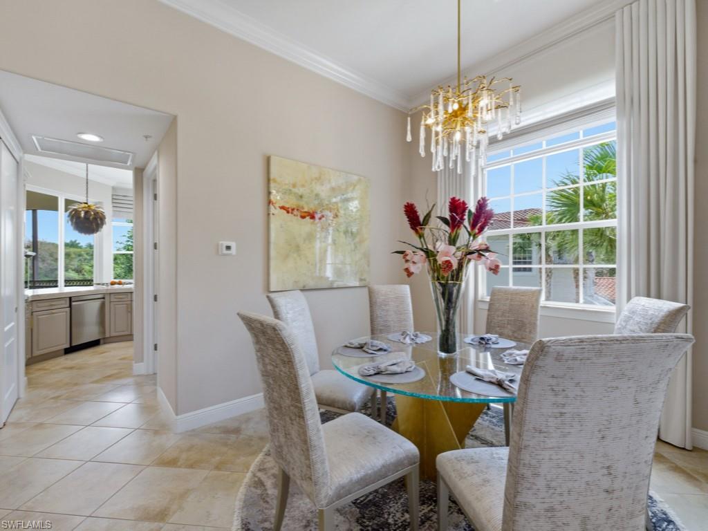 28511 Calabria Court, Unit 202 Naples, FL 34110 - Photo 13 of 44 a view of a dining room with furniture and a chandelier
