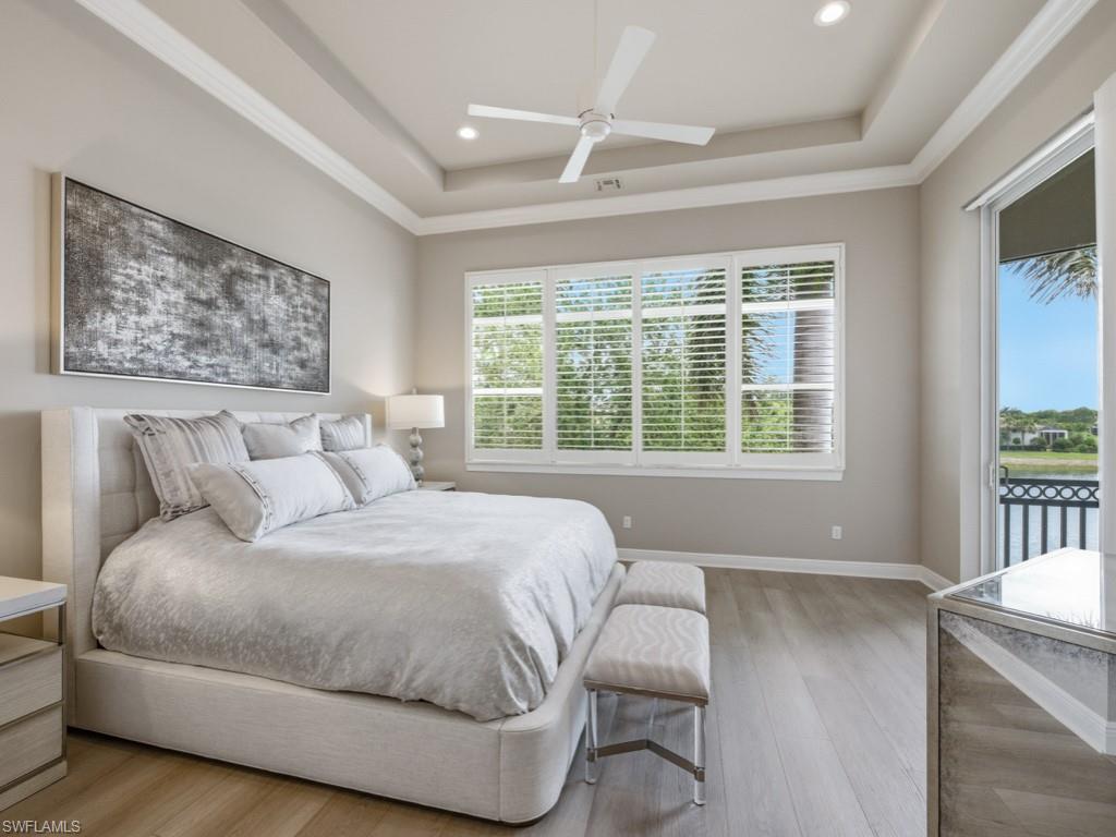 28511 Calabria Court, Unit 202 Naples, FL 34110 - Photo 14 of 44 a bedroom with a large bed and a window
