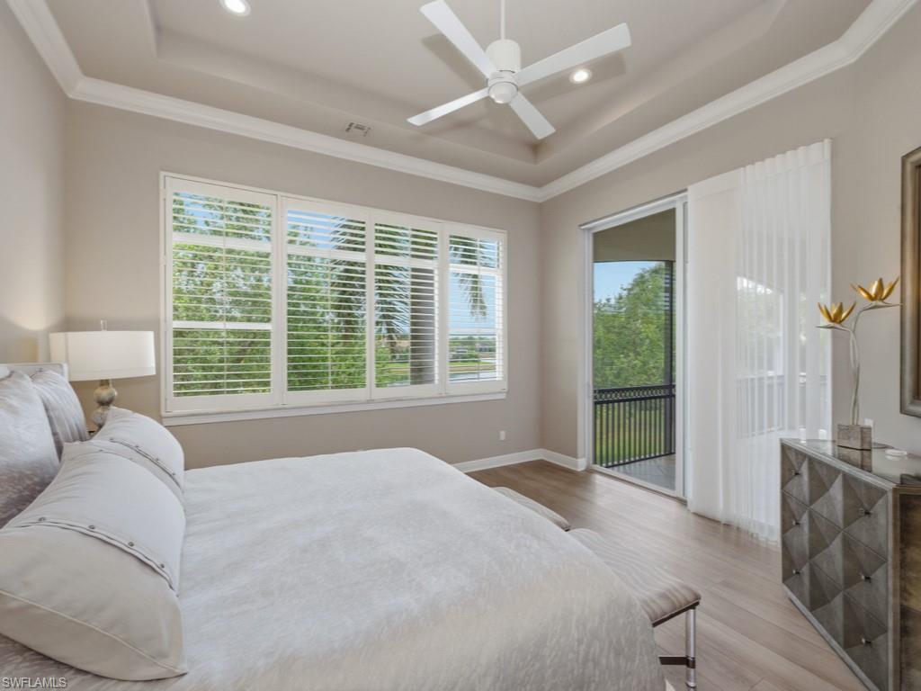 28511 Calabria Court, Unit 202 Naples, FL 34110 - Photo 15 of 44 a spacious bedroom with a large bed and a large window