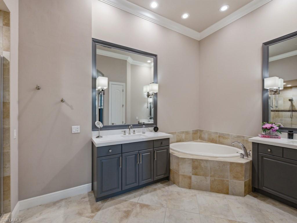 28511 Calabria Court, Unit 202 Naples, FL 34110 - Photo 17 of 44 a bathroom with a bathtub sink mirror and toilet