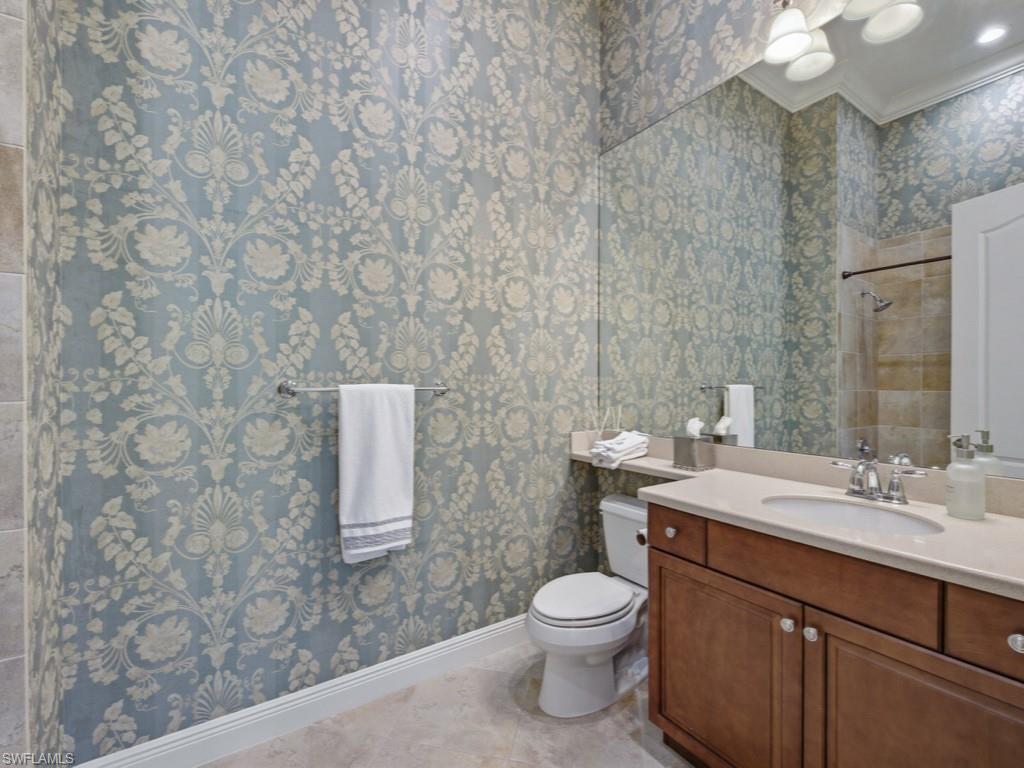 28511 Calabria Court, Unit 202 Naples, FL 34110 - Photo 19 of 44 a bathroom with a sink a toilet and vanity
