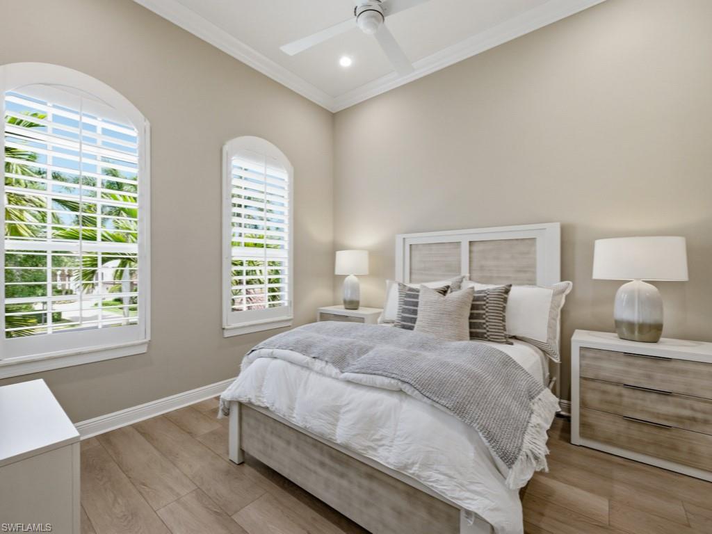 28511 Calabria Court, Unit 202 Naples, FL 34110 - Photo 20 of 44 a bedroom with a large bed and a window