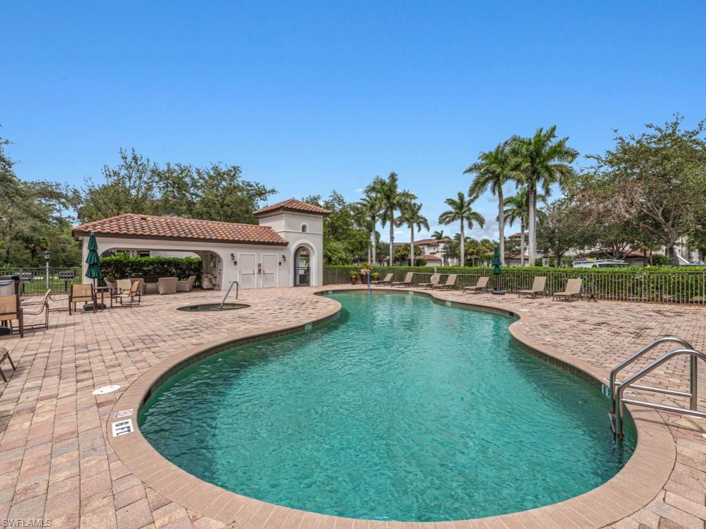 28511 Calabria Court, Unit 202 Naples, FL 34110 - Photo 27 of 44 a view of a swimming pool with a patio