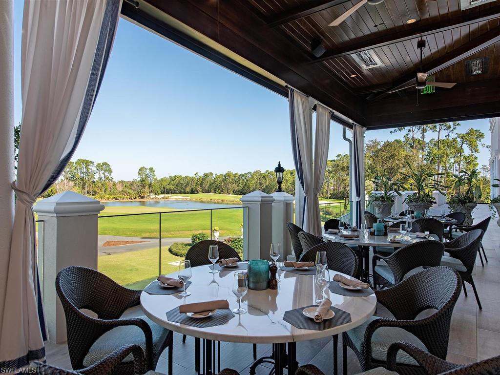 28511 Calabria Court, Unit 202 Naples, FL 34110 - Photo 33 of 44 a view of an outdoor dining space with furniture and garden view
