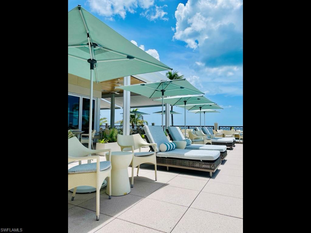 28511 Calabria Court, Unit 202 Naples, FL 34110 - Photo 39 of 44 a outdoor space with patio the couches and a potted plant on the table