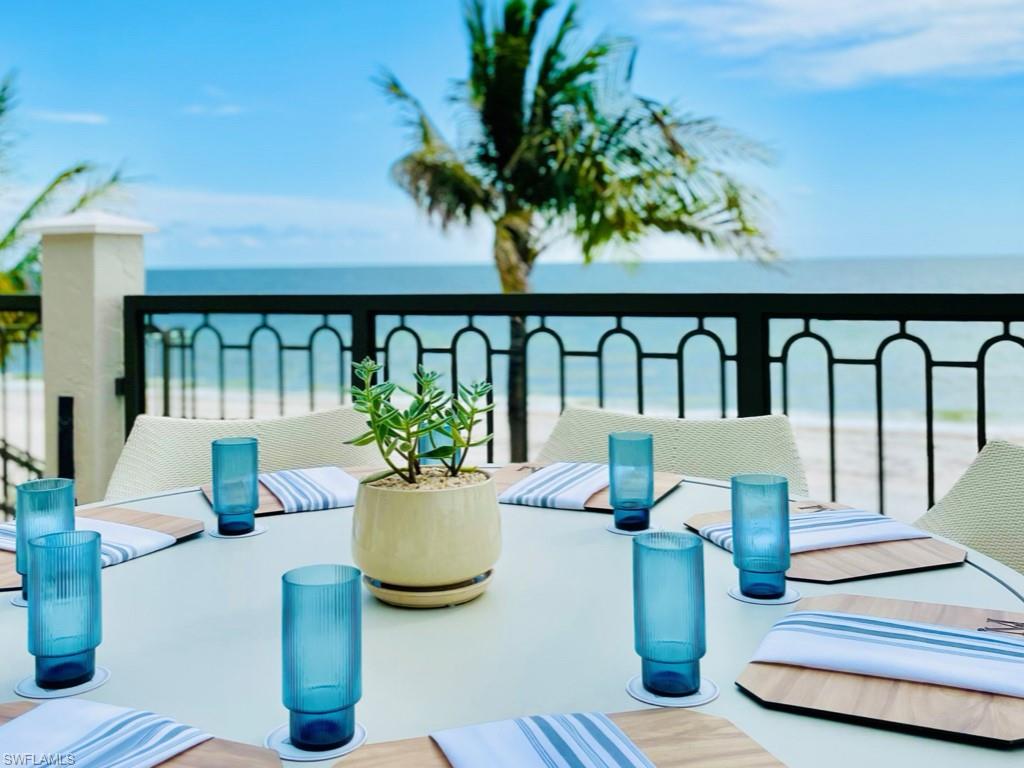 28511 Calabria Court, Unit 202 Naples, FL 34110 - Photo 40 of 44 a view of balcony with dining table and chairs