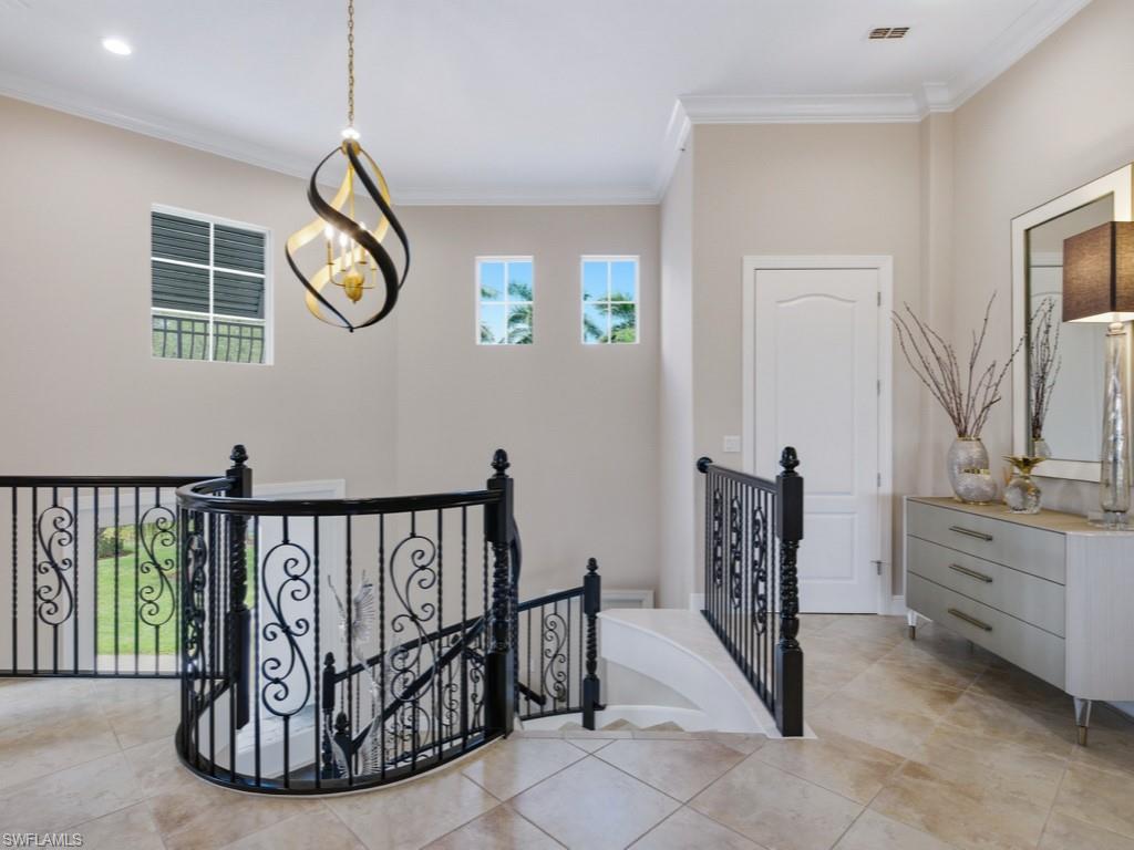 28511 Calabria Court, Unit 202 Naples, FL 34110 - Photo 4 of 44 a view of entryway with wooden floor and windows