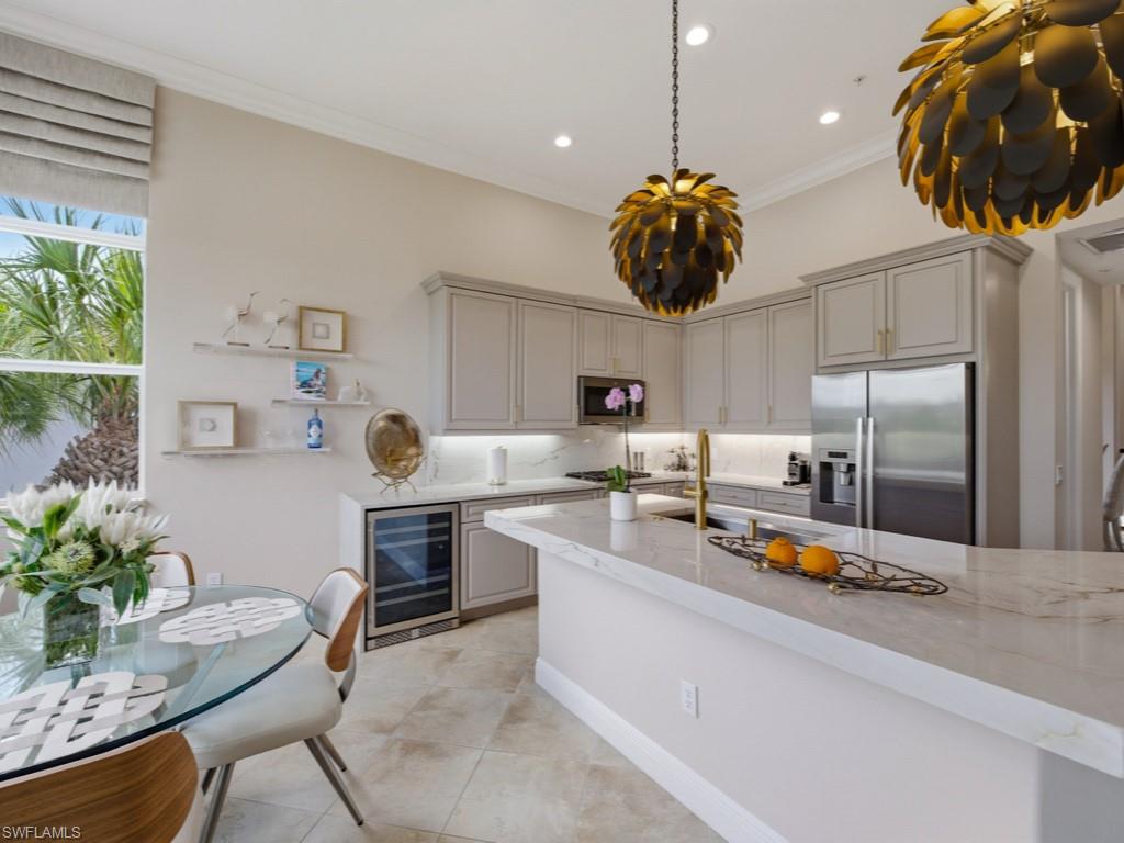 28511 Calabria Court, Unit 202 Naples, FL 34110 - Photo 10 of 44 a kitchen with stainless steel appliances granite countertop a sink a stove and cabinets