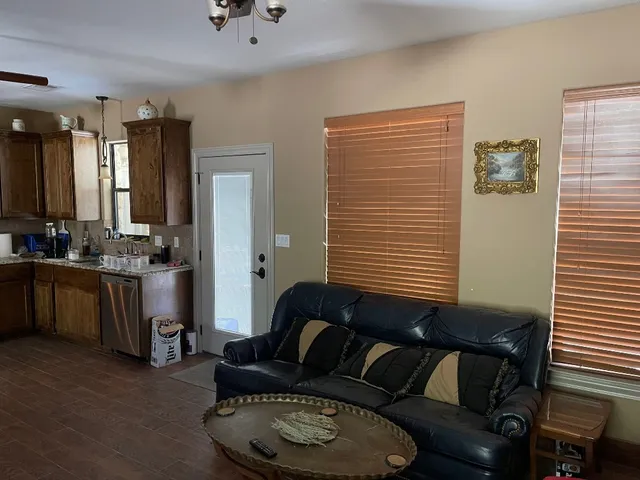 a living room with furniture cabinets and window