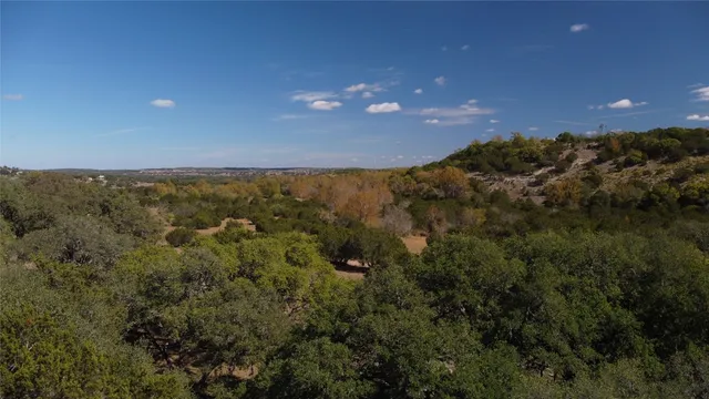 an aerial view of a house with a yard and street view