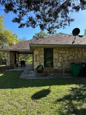 a living room with furniture a window and a flat screen tv