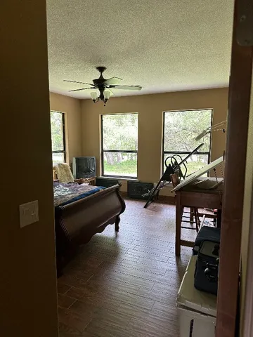 a kitchen with a chandelier a sink stainless steel appliances and cabinets
