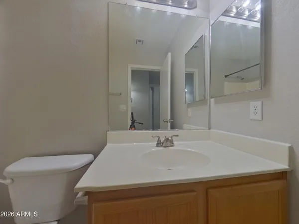 a white toilet and tub sitting next to a bathroom sink