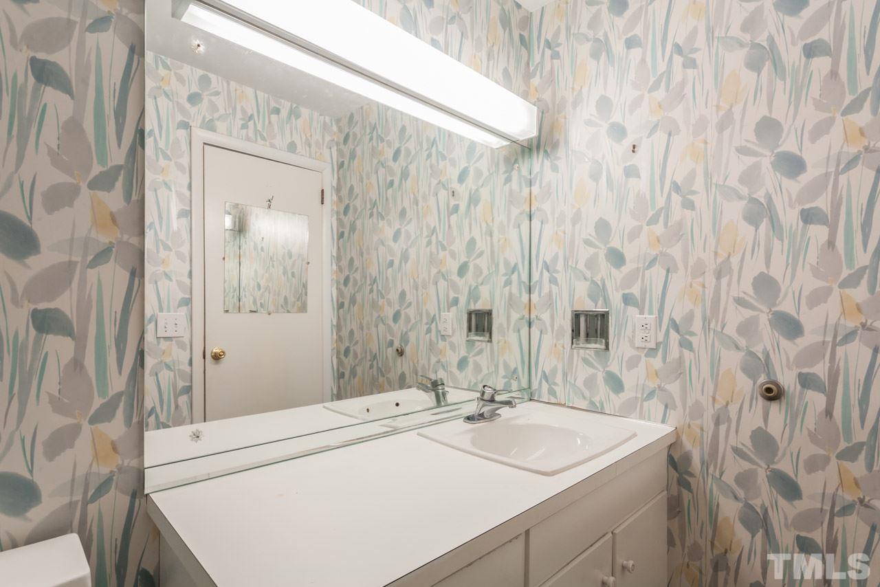 801 Macon Place Raleigh, NC 27609 - Photo 22 of 25 a bathroom with a sink and a mirror