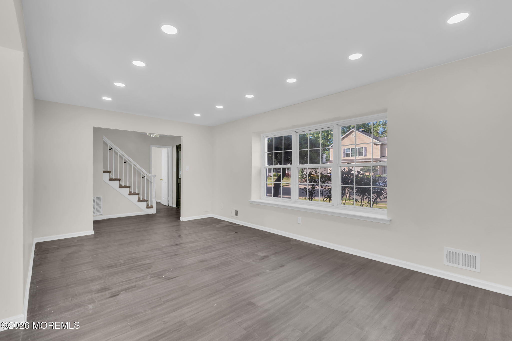 45 Peachstone Road Howell, NJ 07731 - Photo 11 of 54 an empty room with wooden floor and windows