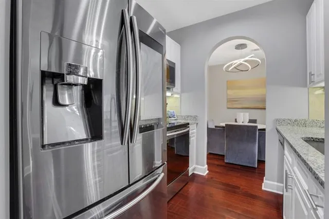 a kitchen with stainless steel appliances granite countertop a refrigerator and a stove