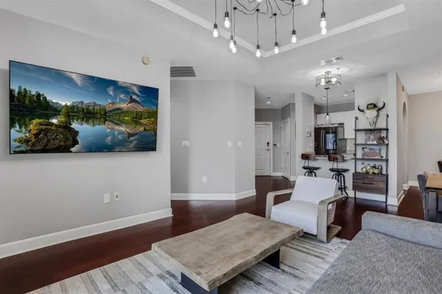 a living room with furniture and a chandelier