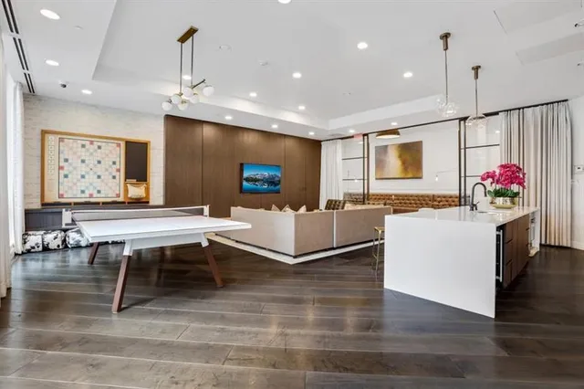 a living room with kitchen island furniture and a flat screen tv