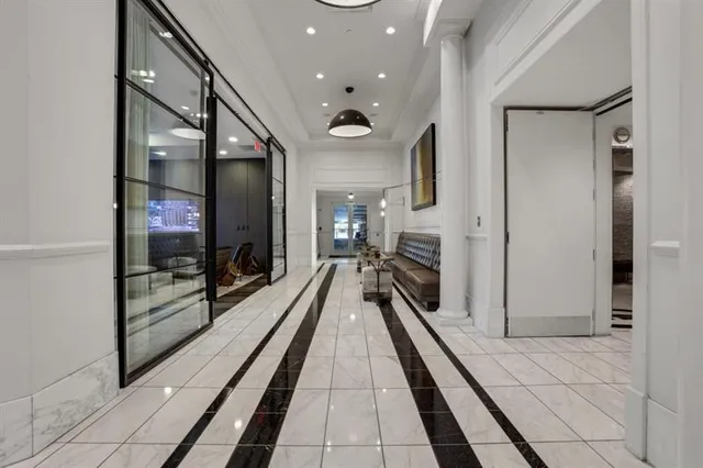 a lobby with a couch and a rug