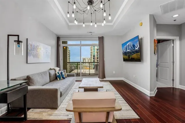 a living room with furniture and a chandelier