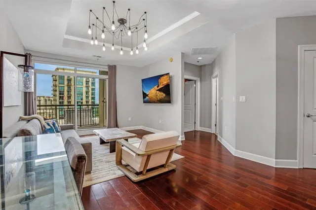 a living room with furniture and a chandelier