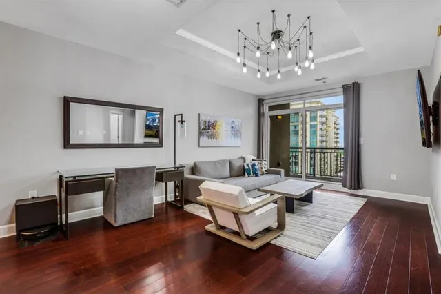 a spacious bedroom with a bed and a chandelier