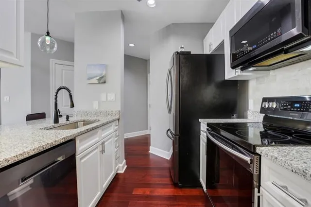 a kitchen with a sink and stainless steel appliances