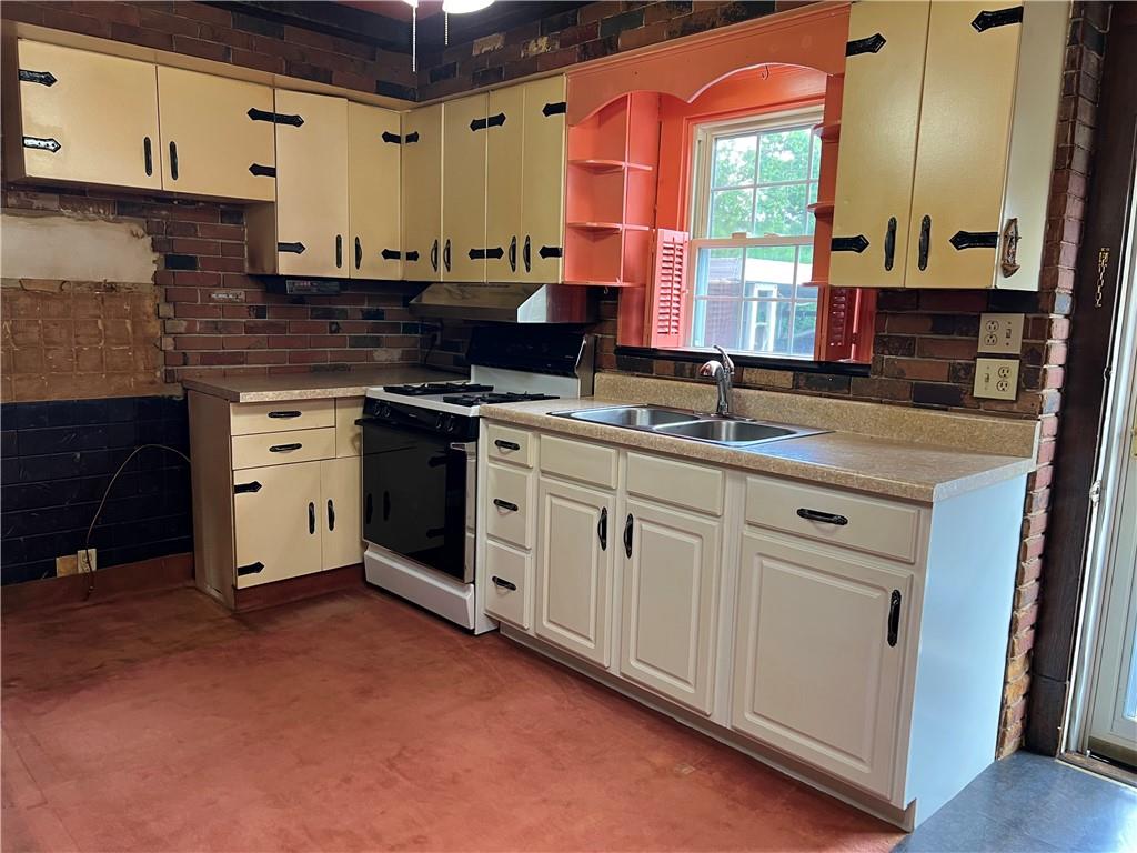 610 Walnut Drive Donora, PA 15033 - Photo 7 of 16 a kitchen with stainless steel appliances granite countertop a stove a sink and a microwave