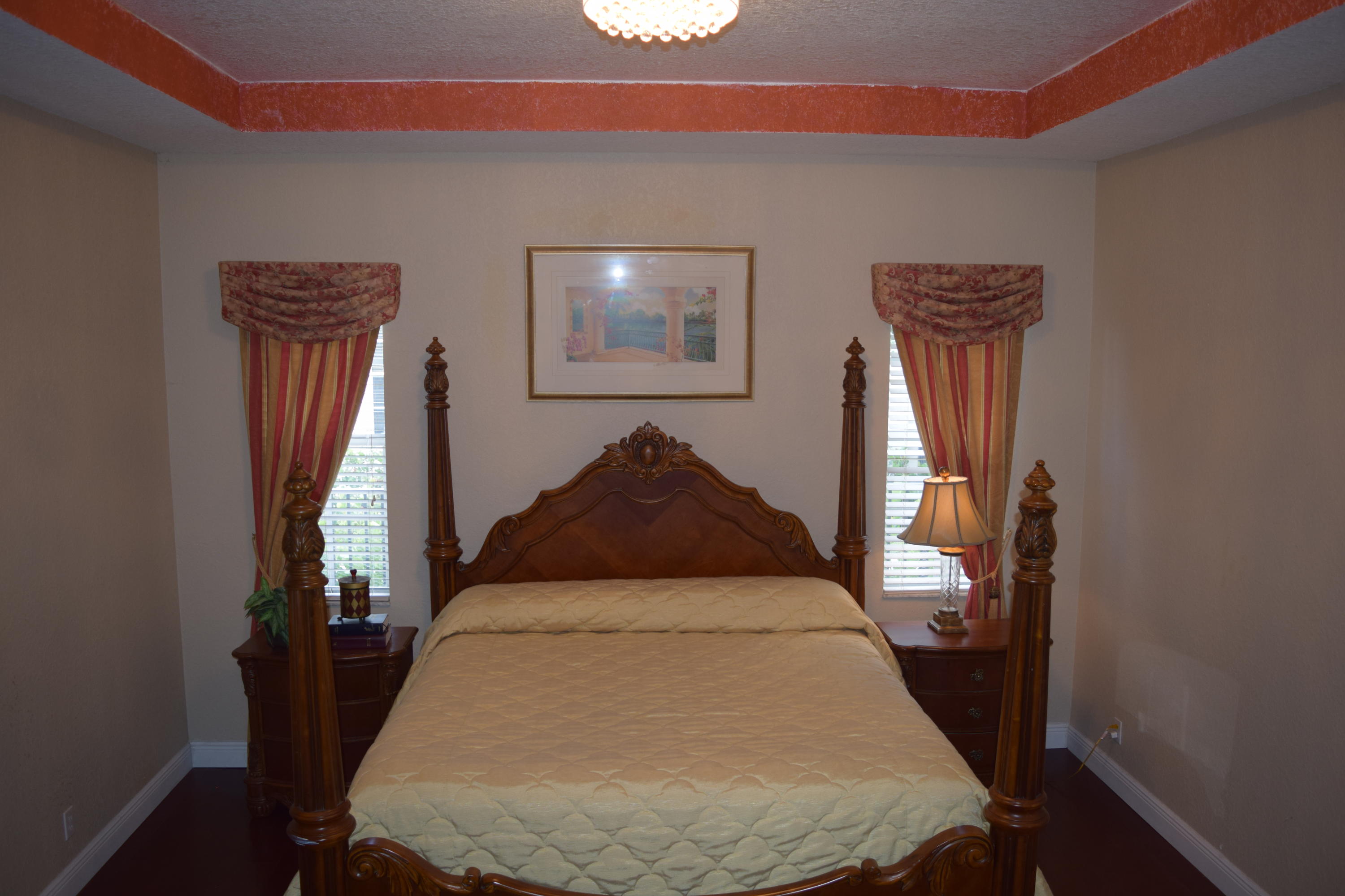132 Via Isabela Jupiter, FL 33458 - Photo 12 of 27 a bedroom with a bed and a mirror