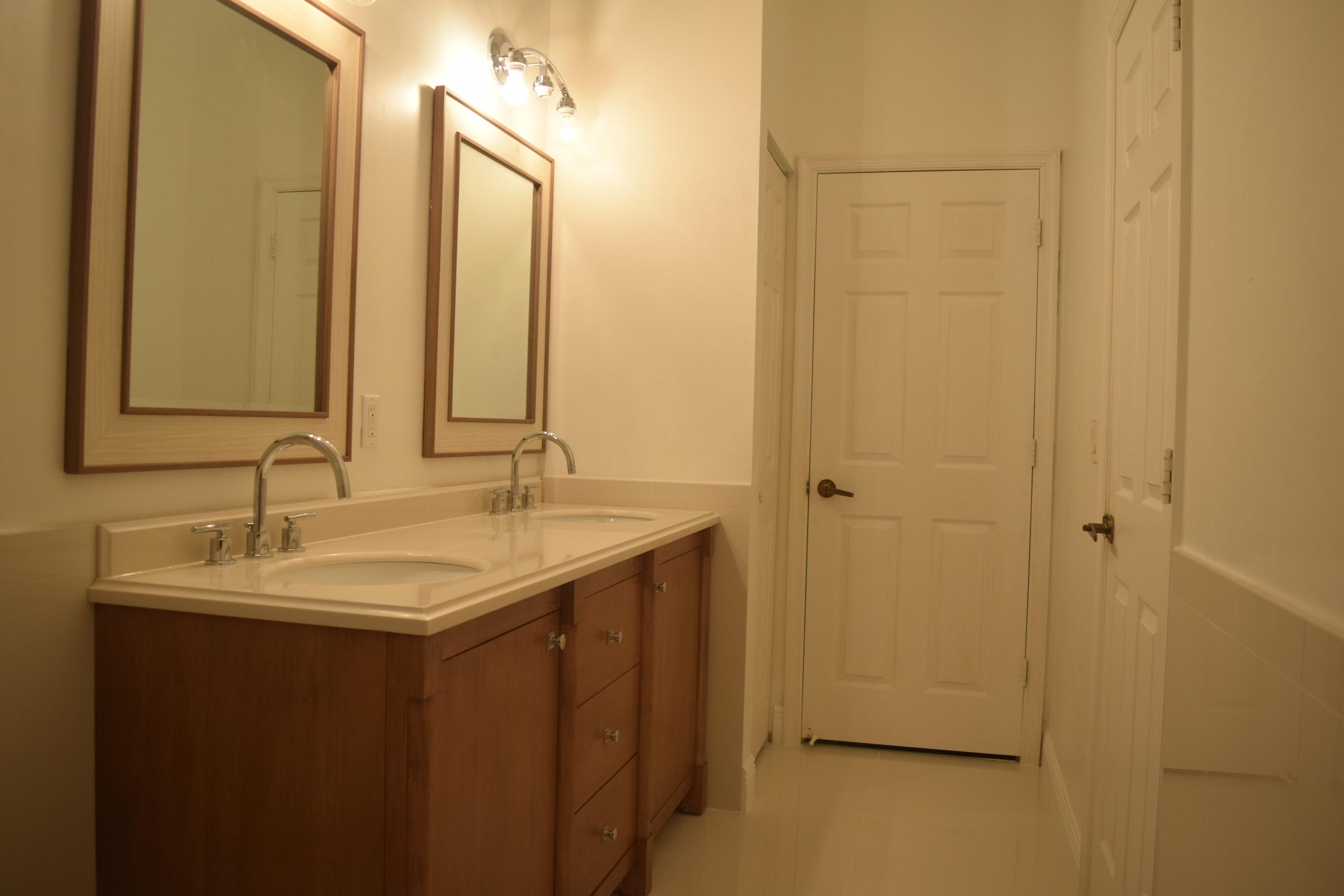 132 Via Isabela Jupiter, FL 33458 - Photo 16 of 27 a bathroom with a sink and a mirror