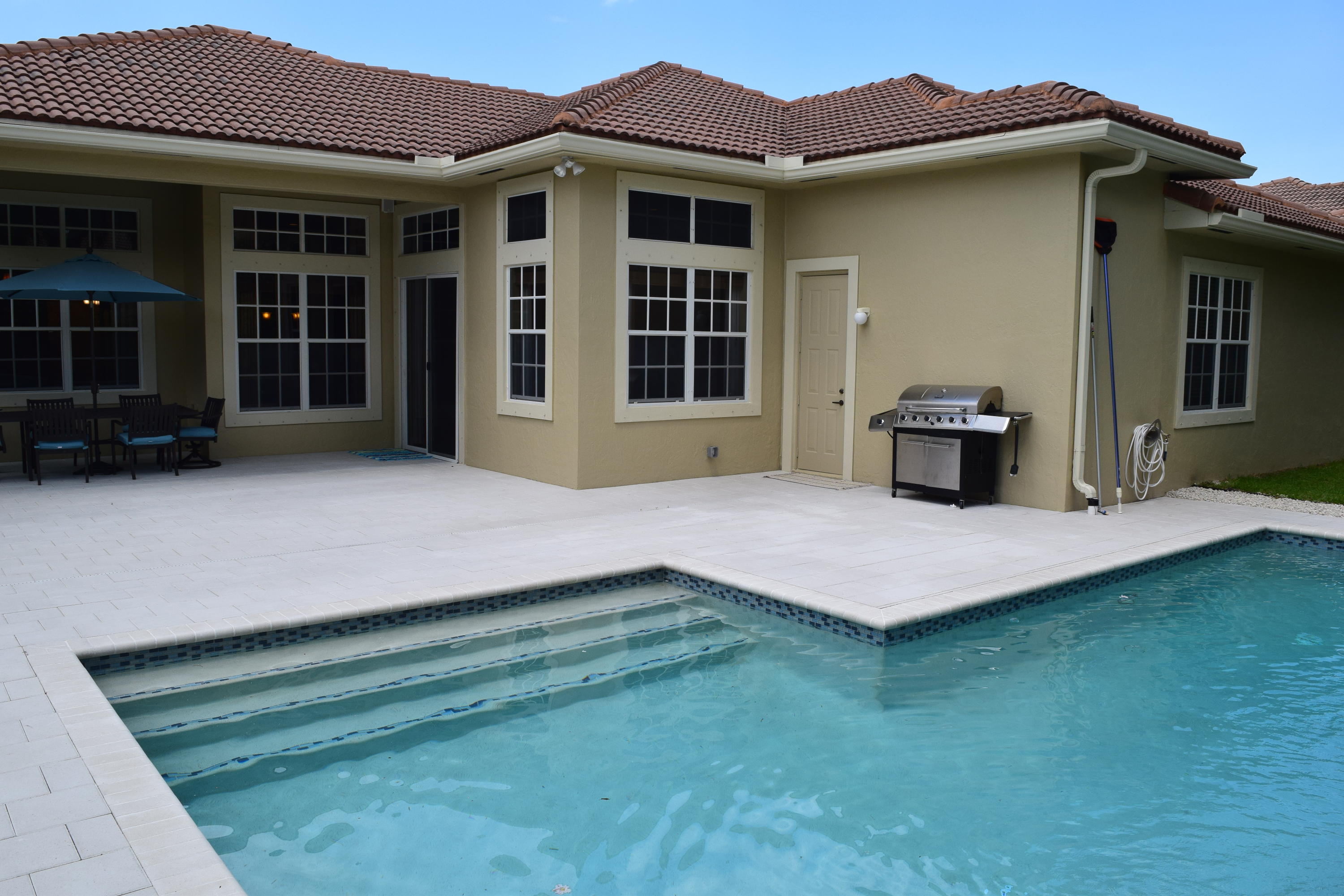 132 Via Isabela Jupiter, FL 33458 - Photo 22 of 27 a front view of a house with a garden and porch