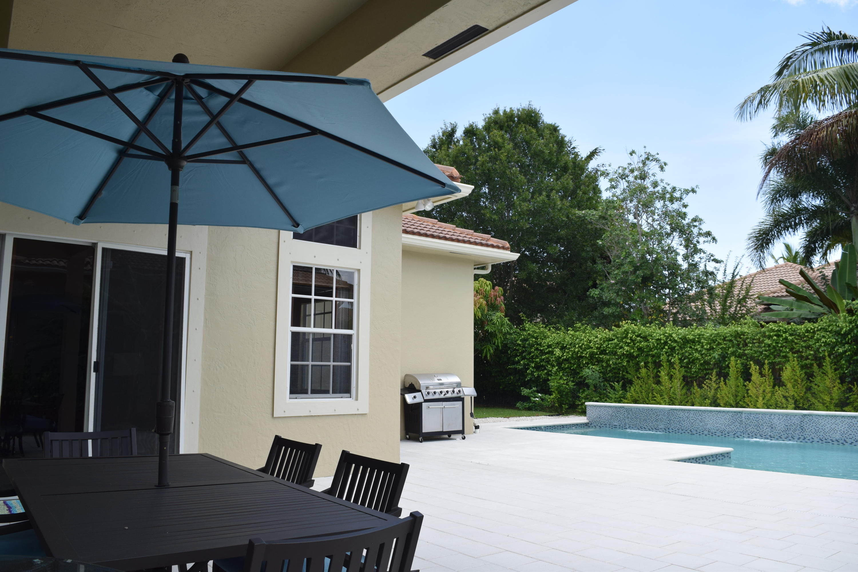 132 Via Isabela Jupiter, FL 33458 - Photo 25 of 27 a view of a table and chairs under an umbrella