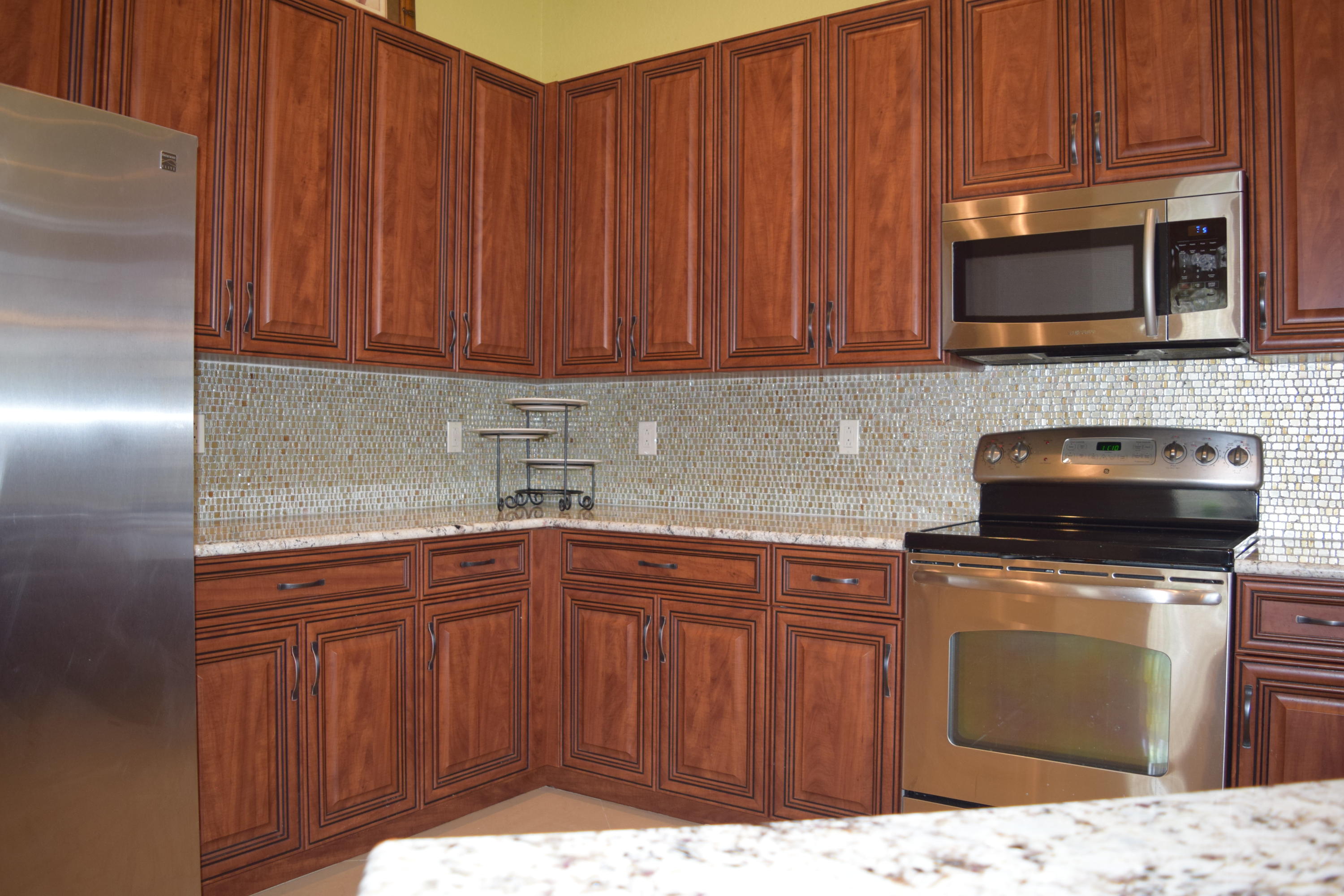 132 Via Isabela Jupiter, FL 33458 - Photo 10 of 27 a kitchen with stainless steel appliances granite countertop a sink stove and microwave