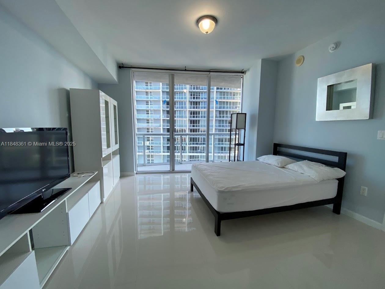 475 Brickell Avenue, Unit 4409 Miami, FL 33131 - Photo 11 of 37 a bedroom with a large bed and a flat screen tv