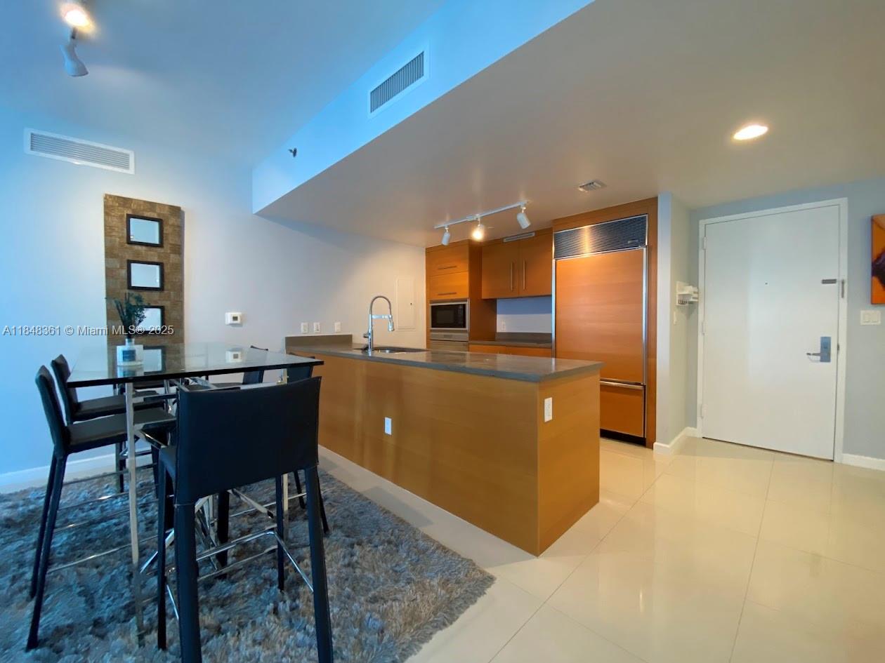 475 Brickell Avenue, Unit 4409 Miami, FL 33131 - Photo 5 of 37 a kitchen with a table and chairs in it