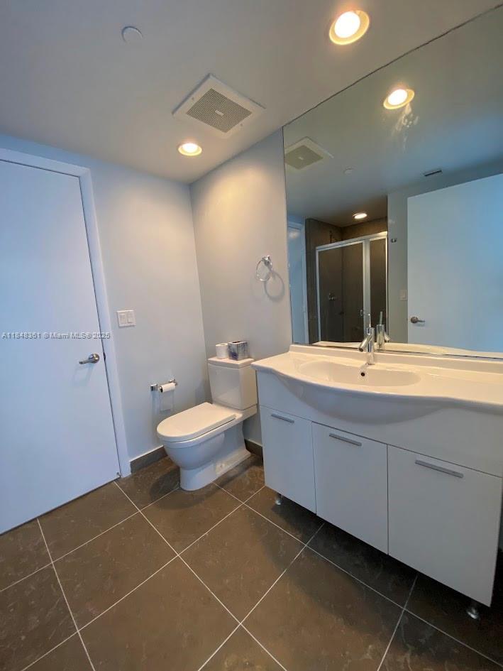 475 Brickell Avenue, Unit 4409 Miami, FL 33131 - Photo 7 of 37 a bathroom with a double vanity sink mirror and toilet