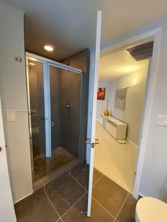 a bathroom with a shower and toilet
