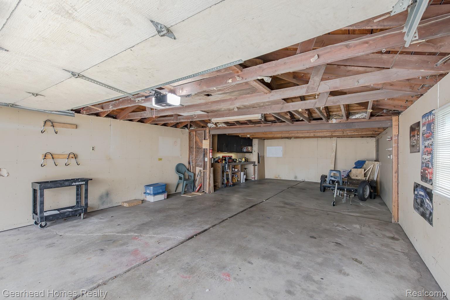 3356 Harding Street Dearborn, MI 48124 - Photo 45 of 48 Concrete flooring with exposed ceiling beams and built-in shelving