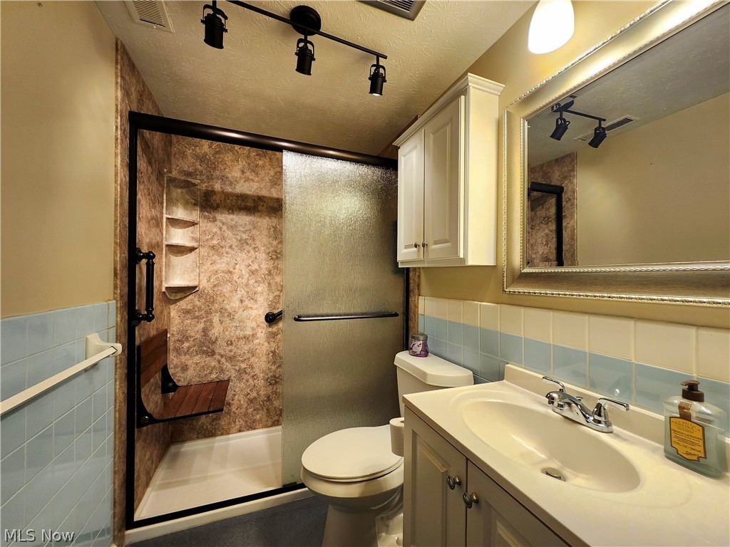 6488 State Road, Unit B 12 Cleveland, OH 44134 - Photo 20 of 46 Updated Bathroom with t vanity, backsplash, toilet & walk-in shower